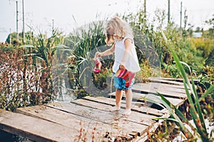 little girl on a wooden bridge