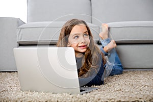 Little girl working with a laptop