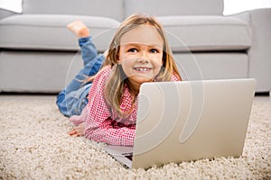 Little girl working with a laptop