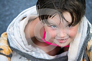 Little girl wrapped in pool towel