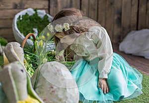 Little girl with wreath among Easter decoration