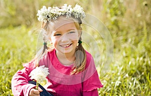 Little girl in wreath of flowers