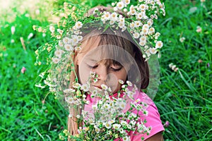 Little girl with a wreath of flowers on her head