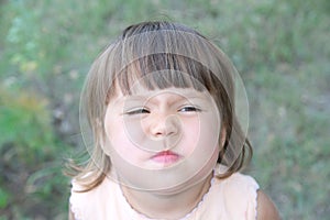 Little girl wrinkle nose making funny face portrait