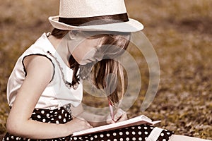 Little girl writes in her notebook