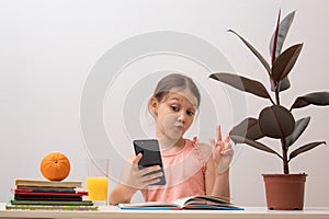 Little girl writes a message on a smartphone. Youth Communication Concept