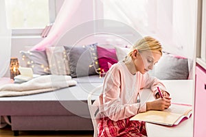 Little girl writing diary