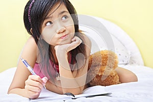 Little girl writing her diary photo