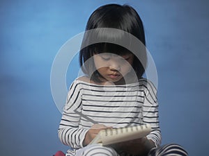 Little Girl Writing on Notepad