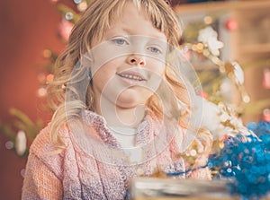 Little girl with Xmas present on Christmas Eve