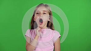 Little girl yawns. Green screen. Slow motion