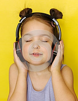 Little girl on a yellow background