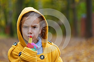 Little girl in yellow coat put