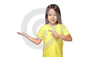 Little girl in yellow t-shirt holding her hand out