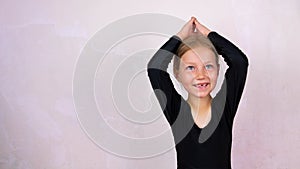 Little girl on yoga class in Siddhasana lotus pose on mat smiling. Online stretching practicing for children, flexibility health