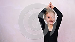 Little girl on yoga class in Siddhasana lotus pose on mat smiling. Online stretching practicing for children, flexibility health