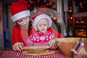 Little girl with young mother baking Christmas