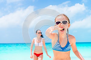 Little girl and young mother at tropical beach