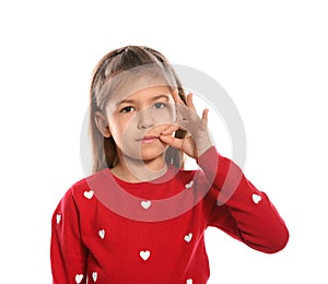 Little girl zipping her mouth. Using sign language