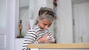 Little GirlChild Home On Sofa Playing With Pet Hamster. Concept of Friendship of children and Animals.