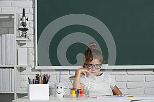 Little girls drawing a colorful pictures with pencil crayons in school classroom. Painting kids. Kids art, creativity