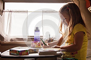 Little girls drawing in train travelling with family, Russia