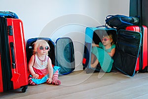 Little girls enjoy packing and travel, family going on vacation