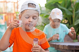 Little girls enthusiastically inflated bubbles in street