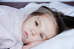 Little girls going to sleep lying on bed. sleep schedule in domestic lifestyle. cute child portrait