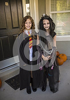 Little girls going trick or treating on Halloween in their costume