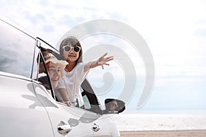 Little Girls happy traveling car travel enjoy holidays and relaxation. Hatchback Car travel driving road trip of family summer