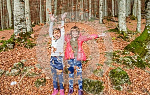 Little girls having fun with laves in autumn in Biogradska Gora