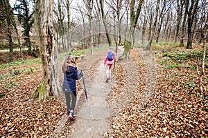 Little girls hiking through autumn forest