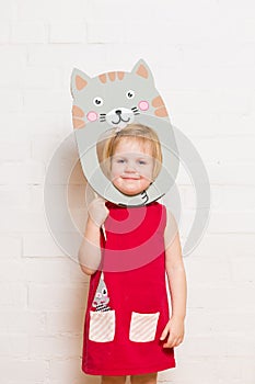 Little girls holding cat mask on white background