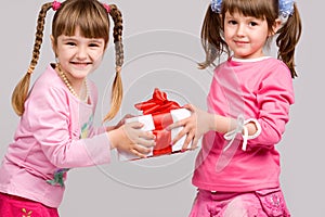 Little girls holding gift boxes