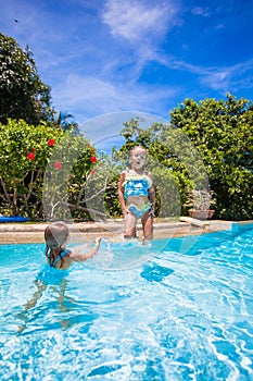 Little girls jumping and having fun in swimming
