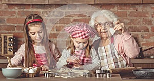 Little girls making cookies with her granny