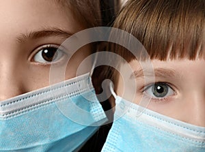 Little girls in medical masks. Virus protection