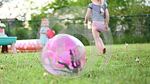 Little girls playing in backyard in summer