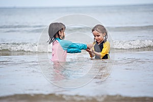 Little girls playing on the beach, family beach vacation