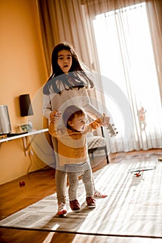 Little girls playing on the floor in the room