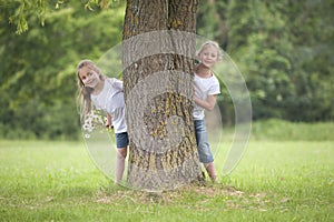 Little girls playing hide and seek photo