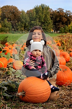 Little girls in pumpkin patch