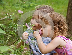 Little girls smelling flowers