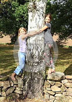 Little girls on stone wall