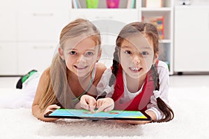 Little girls using tablet computer as artboard