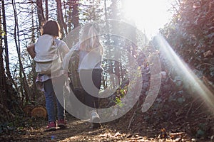 Little girls are walking on the mountain path during a trip with little excursionists