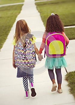 Little girls walking to school together