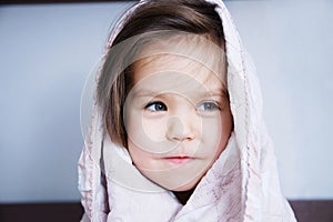 Little girls wrapped in blanket going to sleep sitting on bed. sleep schedule in domestic lifestyle. cute child portrait