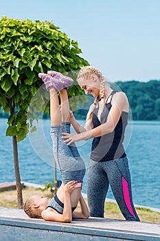 Little girt and woman are doing exercises